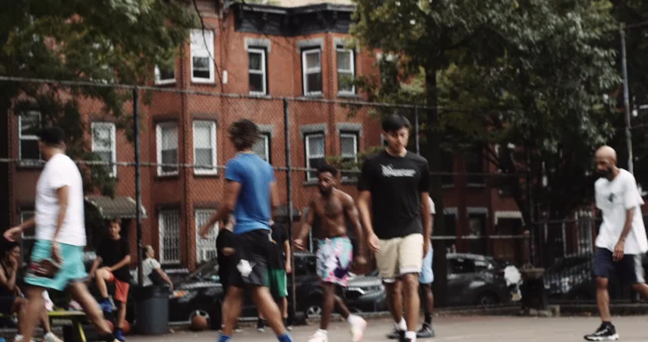 People walking to their positions on a basketball court.